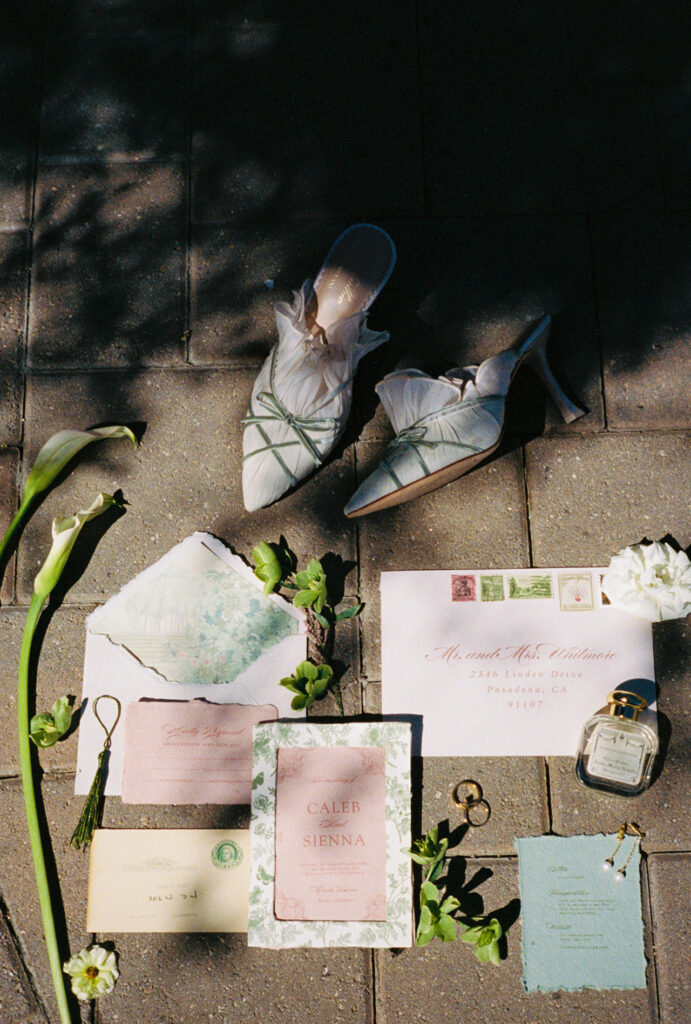 Flat lay of Cielo Farms wedding invitation suite and floral details